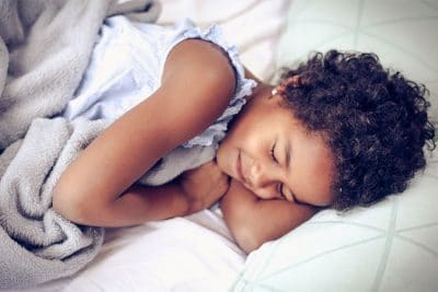 young child sleeping in bed