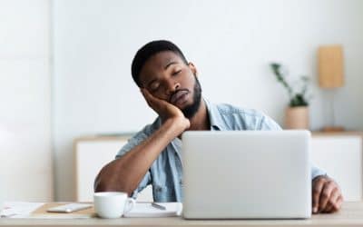 tired man falling sleep at his laptop
