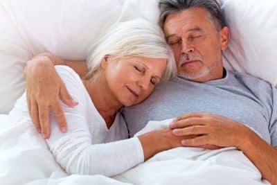 mature couple sleeping soundly in bed thanks to Myofunctional Therapy in Columbus, Ohio